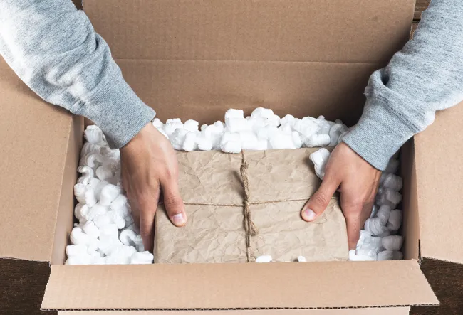 Moving box with packing peanuts